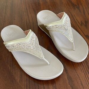 These beautiful gold flip-flops have only been worn one time.